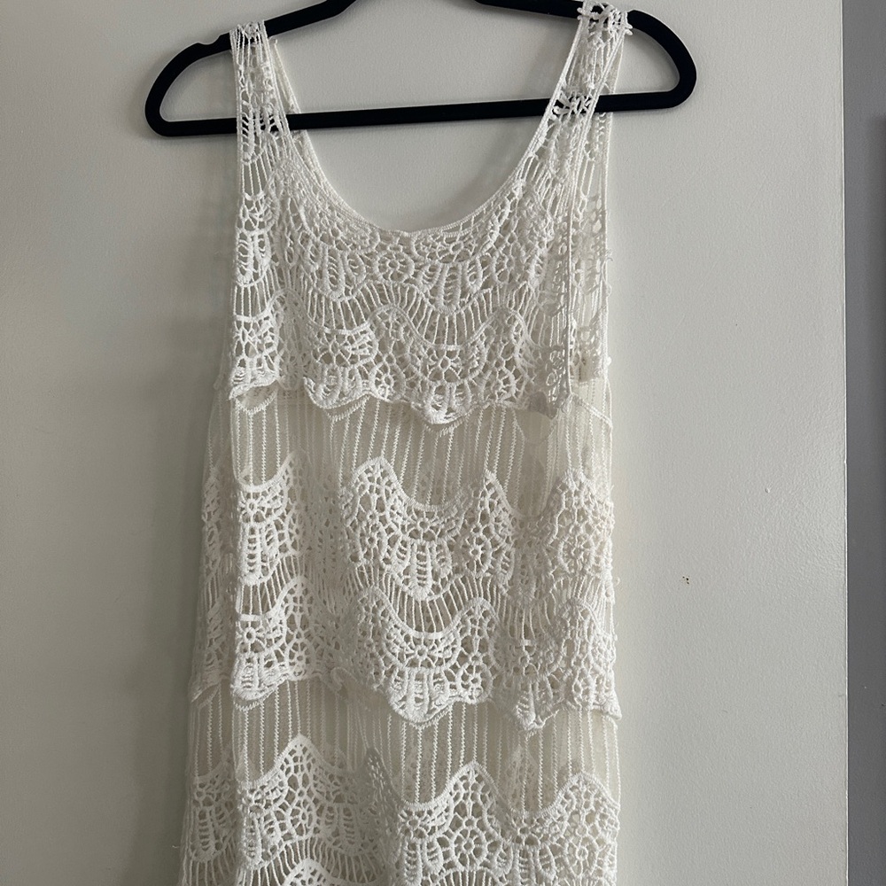 White lace crochet dress with a lace hem,